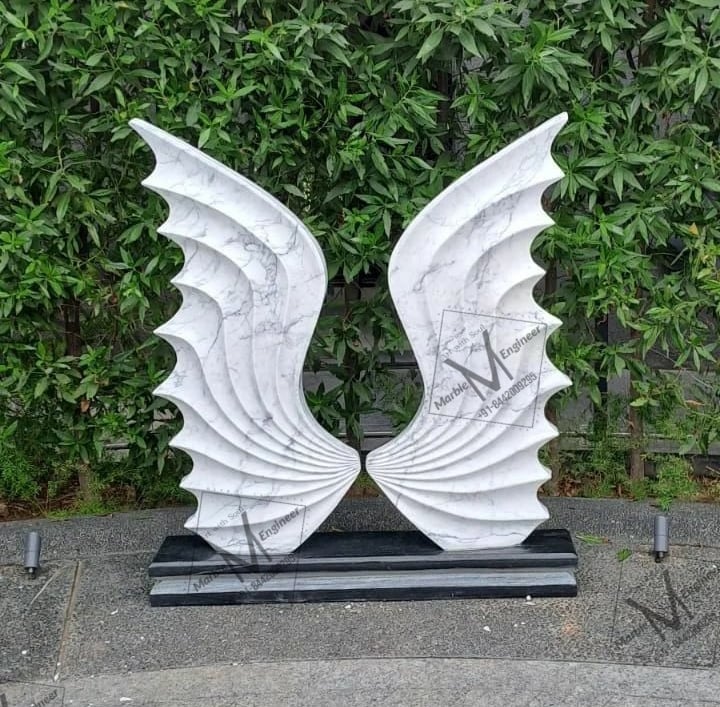 a pair of white sculptures of wings