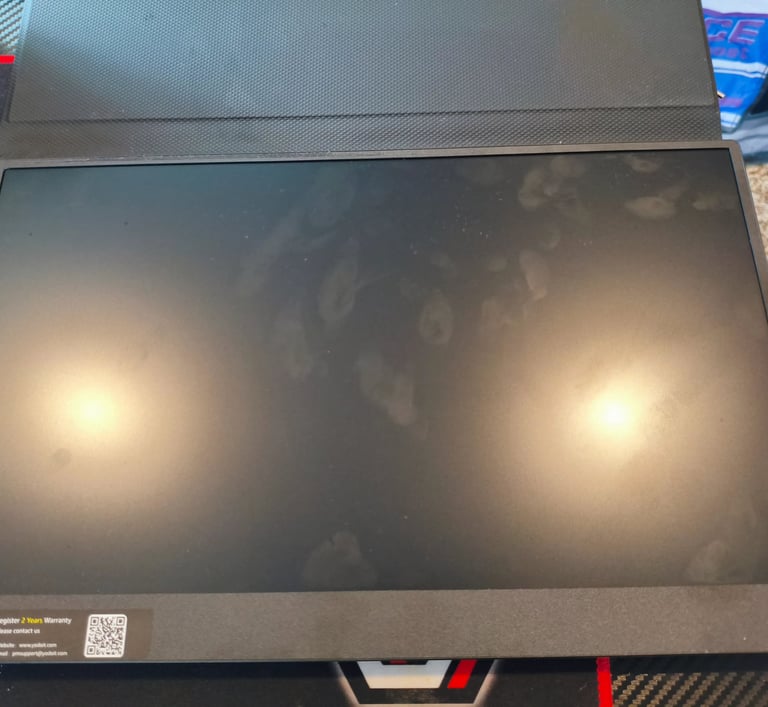 Monitor portátil com ecrã apagado sobre mesa de escritório