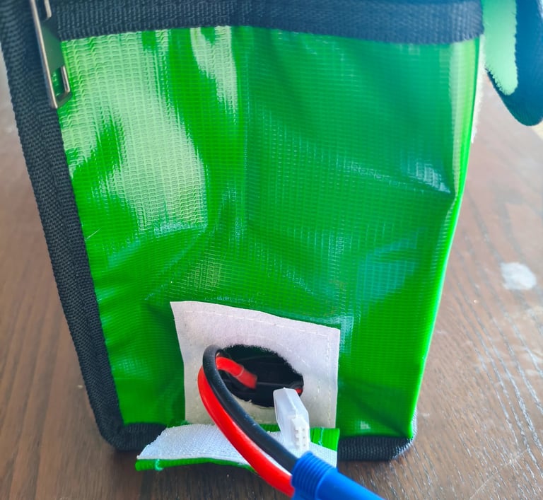 Análise da ranhura passa-cabos com velcro em mala ignífuga Ovonic Lipo Guard para carregamento segur