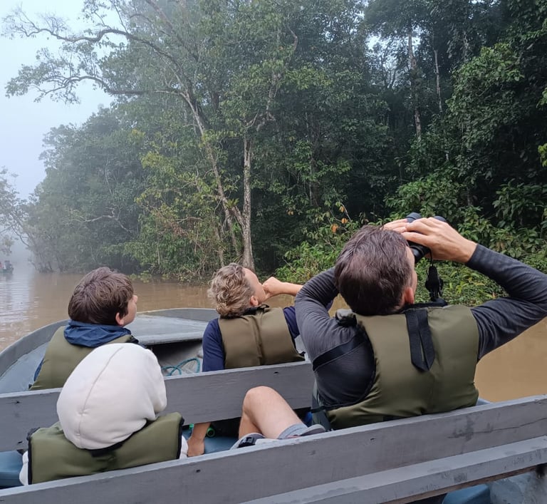 a group of people in a boat on a river 