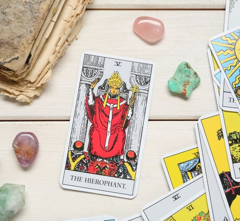 The Hierophant tarot card on a stack with crystals for tarot study and learning.