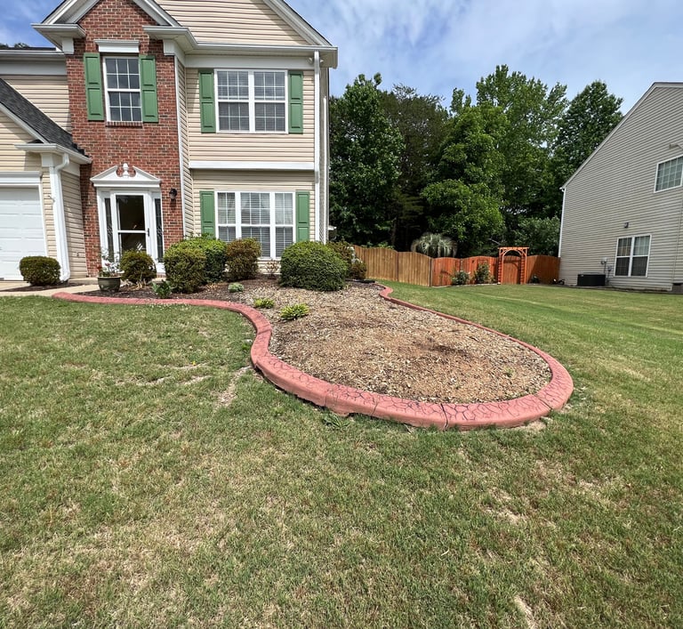 Front flower bed with red cement border that had a large tree removed with are for us to design.