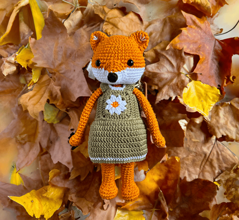 handmade amigurumi fox in a green dress