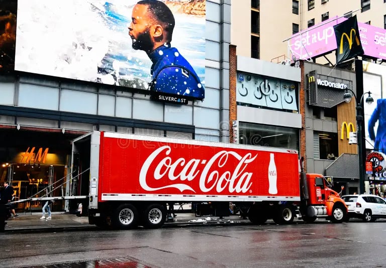 a coca cola cola cola truck parked on the street