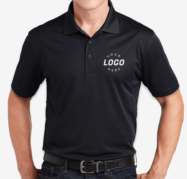 a man in a black shirt and jeans jeans standing in front of a white wall