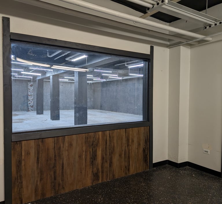 Observation room overlooking a studio through a large window