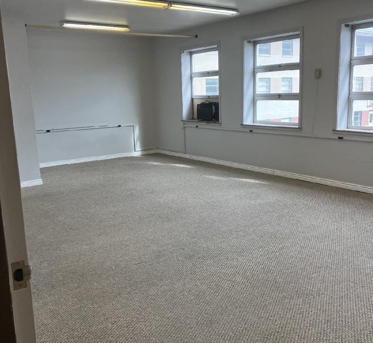 Unfurnished office with 3 windows along 1 wall