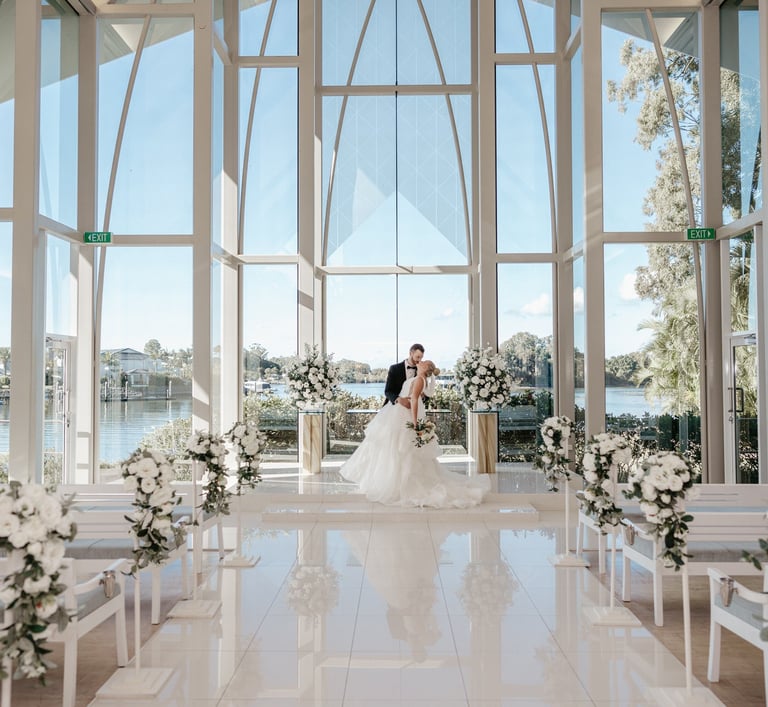 a bride and groom standing in front of a church