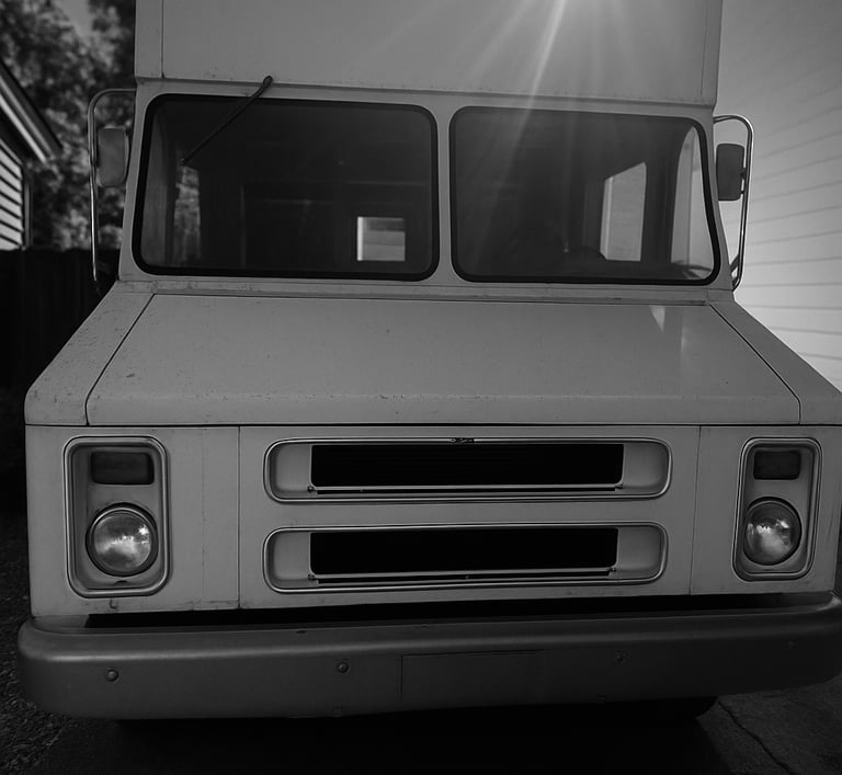 a truck with a sun shining through the windshield