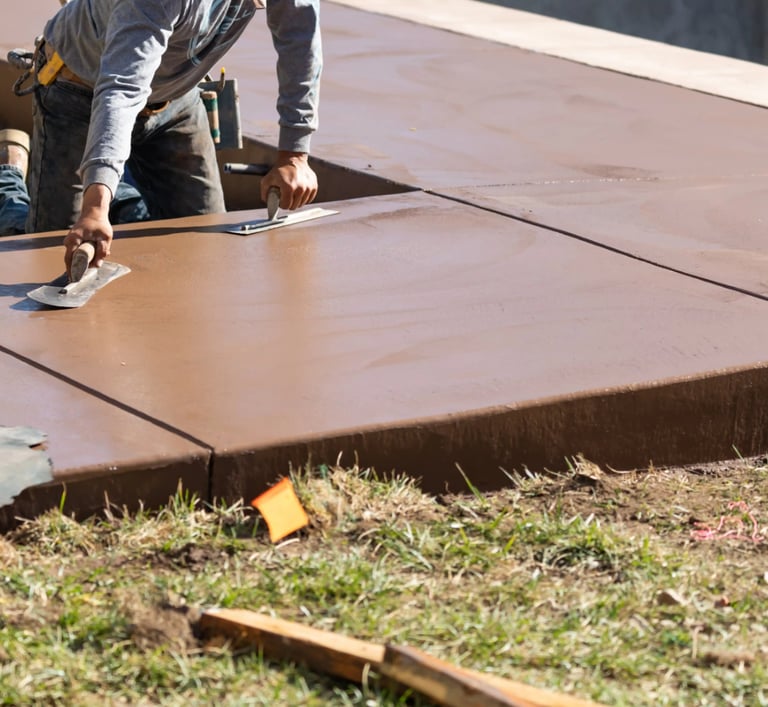 a man is using a knife to cut a concrete slab