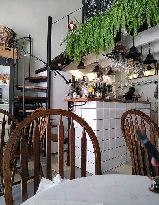 a restaurant with a table and chairs and a staircase