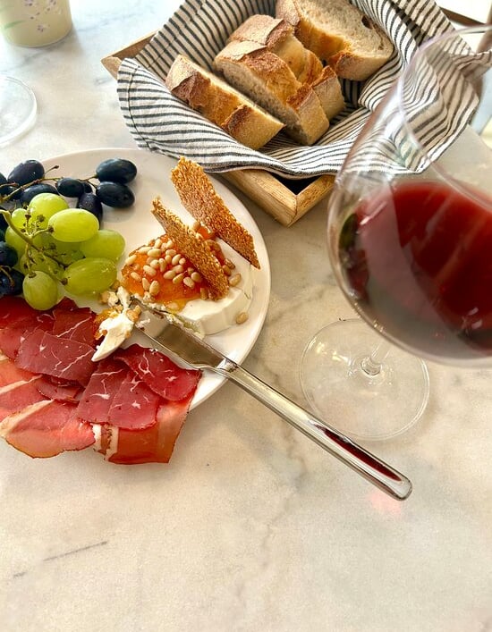 a plate of food and wine glasses on a table