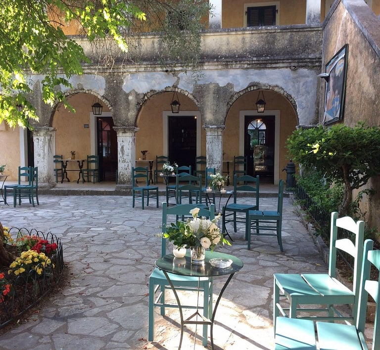 a patio with chairs and tables in a courtyard