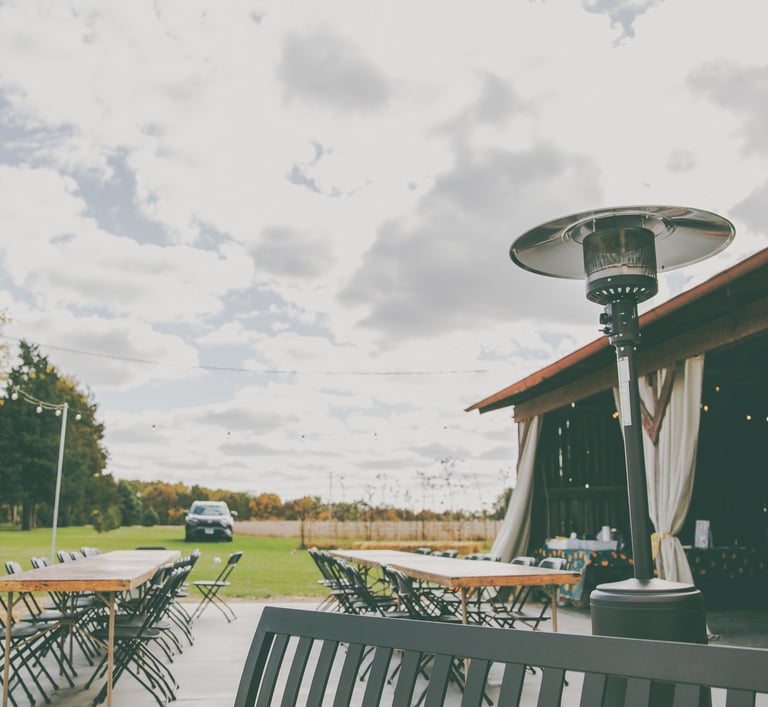 a patio with a table and chairs and a propane heater