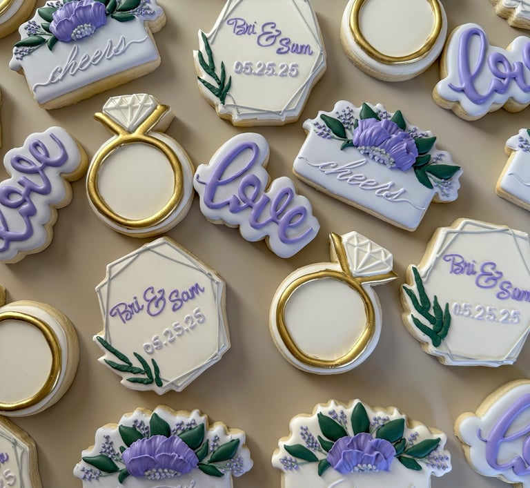 a bunch of cookies decorated in a bridal shower theme