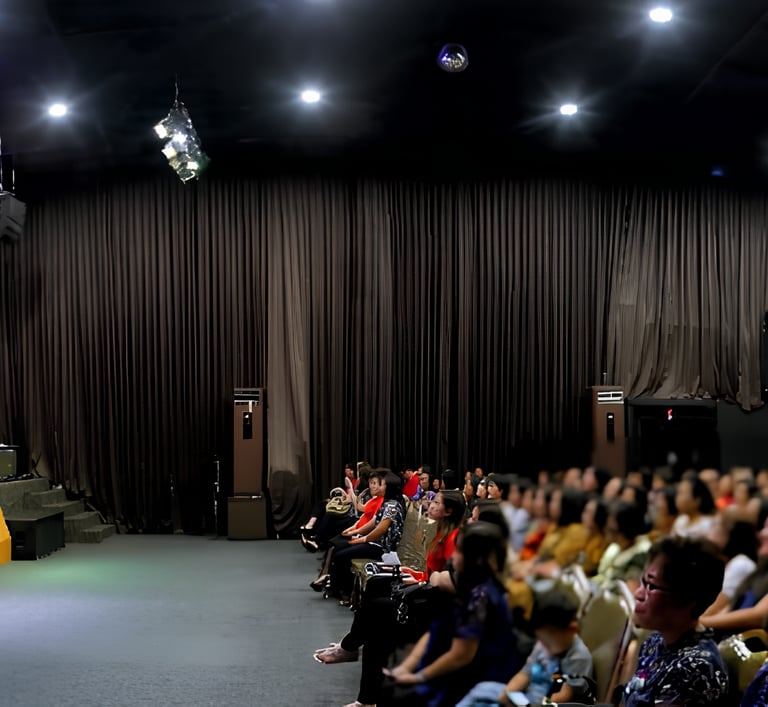 a large group of people standing in front of a stage