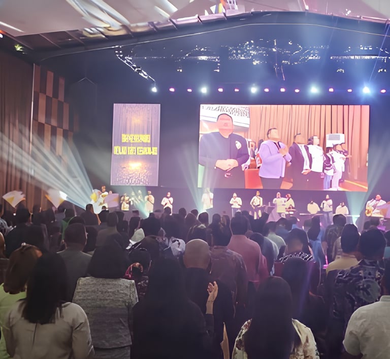 a large group of people standing in front of a stage