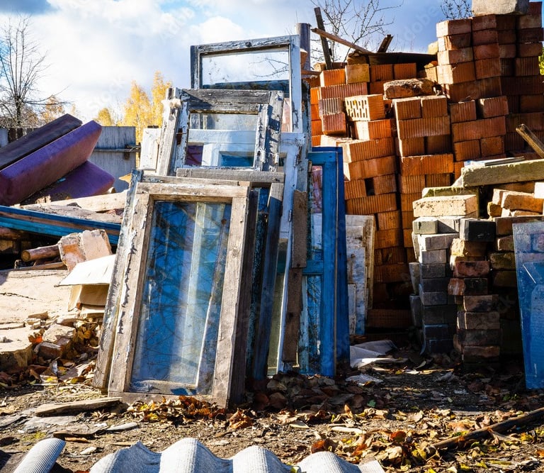 construction debris stacked on empty lot