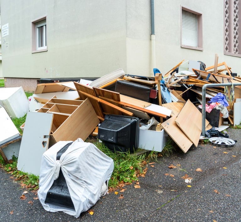 junk stacked along driveway