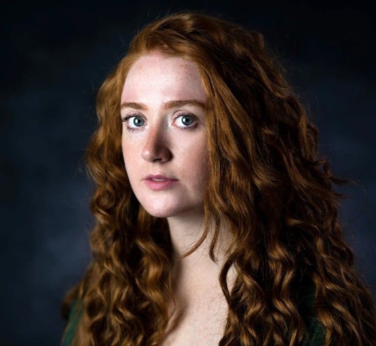 a woman with long red hair and blue eyes