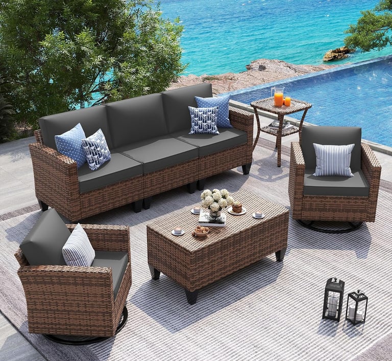 Modern 5-piece brown wicker patio furniture set with grey cushions on a pool deck overlooking the ocean.