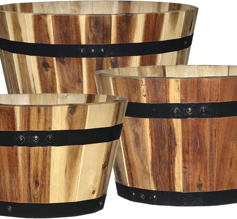 Set of three rustic wooden barrel planters with black metal bands for garden decor.