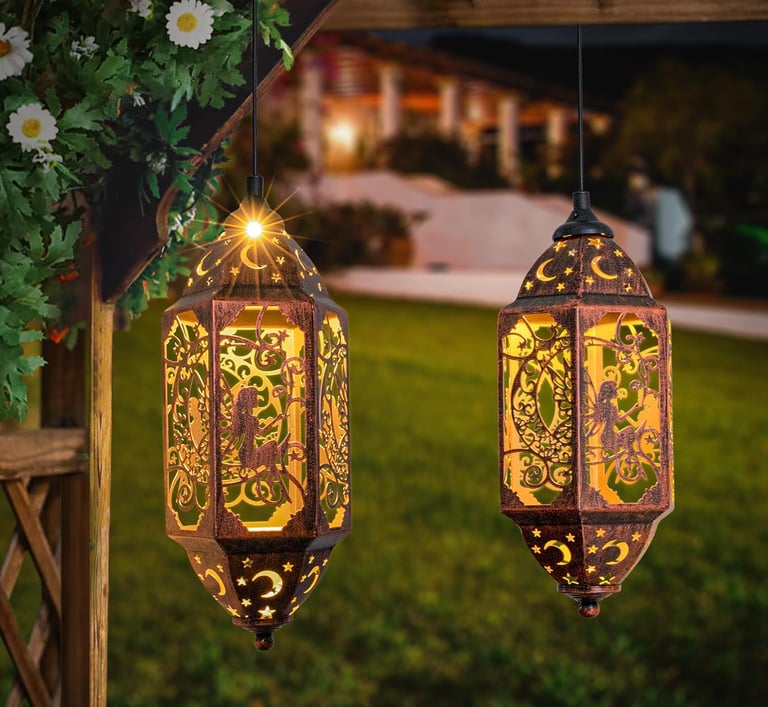 Two decorative solar-powered garden lanterns with moon and star cutouts hanging on a wooden pergola at night.