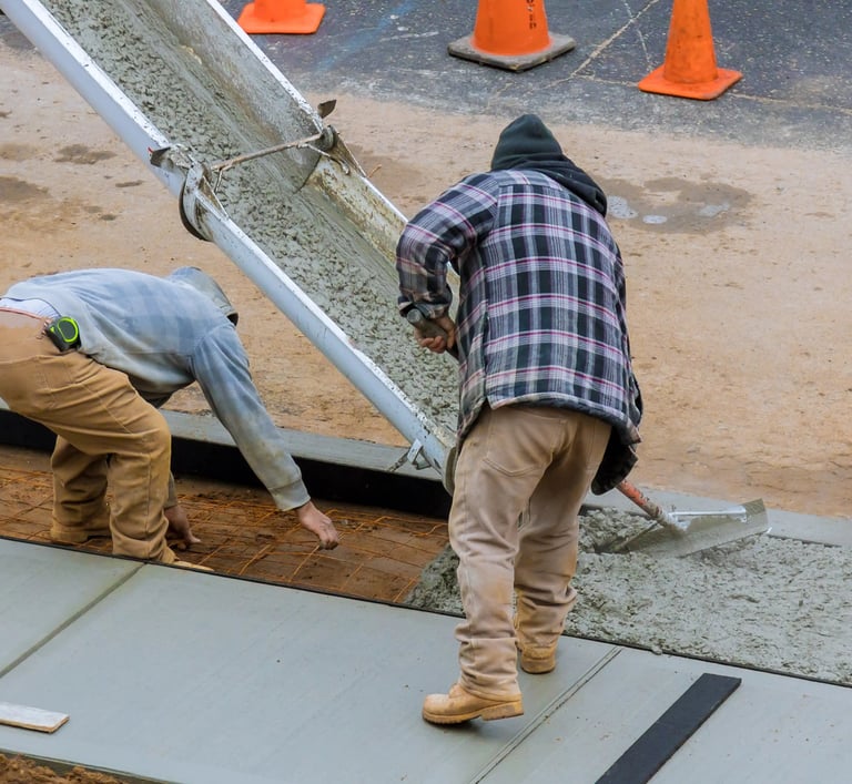 two men working on a concrete slab