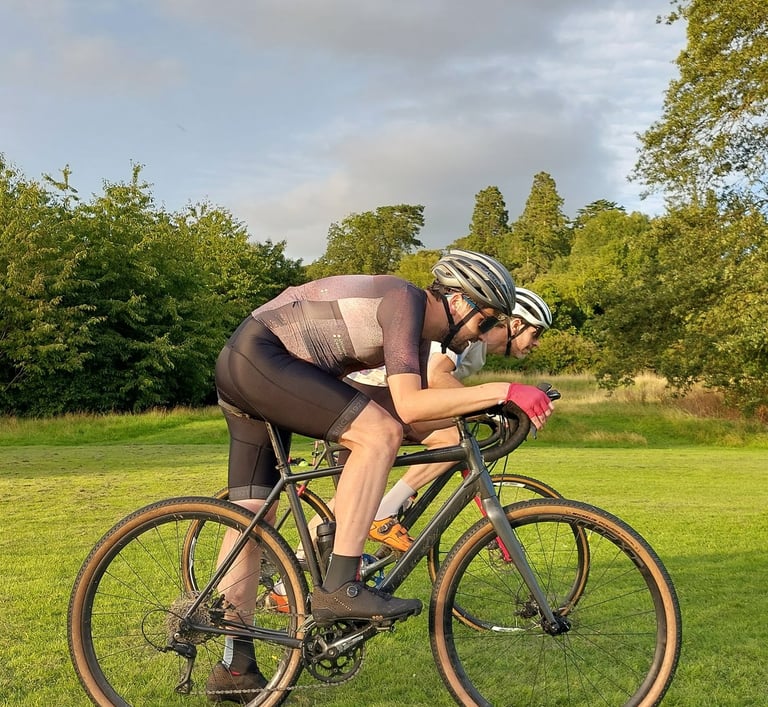 Two men practicing cyclocross race stars during a coaching session
