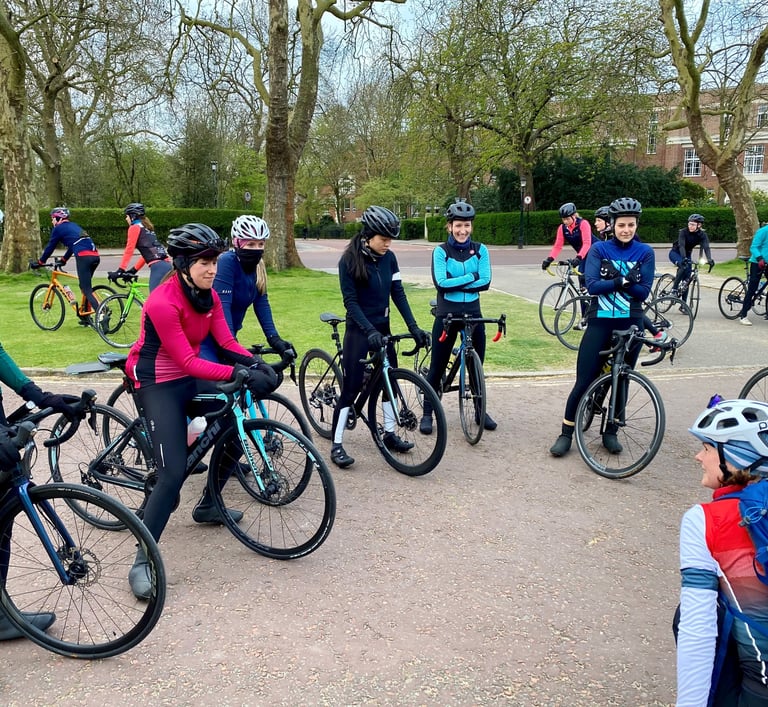 Liz Hughes coaching a group of women on road bikes