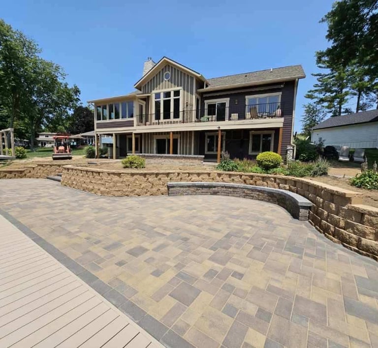 A custom paver patio, retaining wall, and bench by Kingdom Landscape in Heritage Lake Indiana