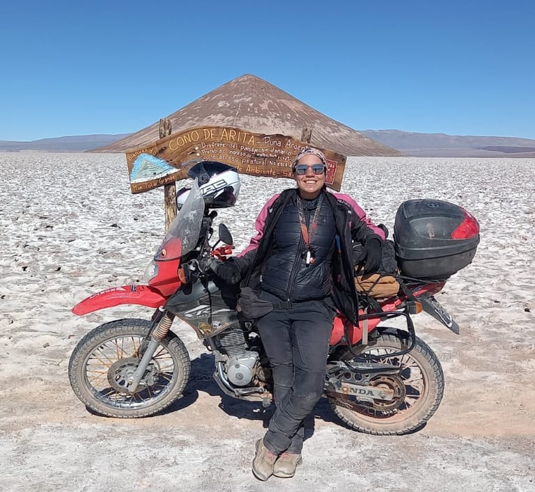 a man sitting on a motorcycle in the desert cono de arita puna atacama salar