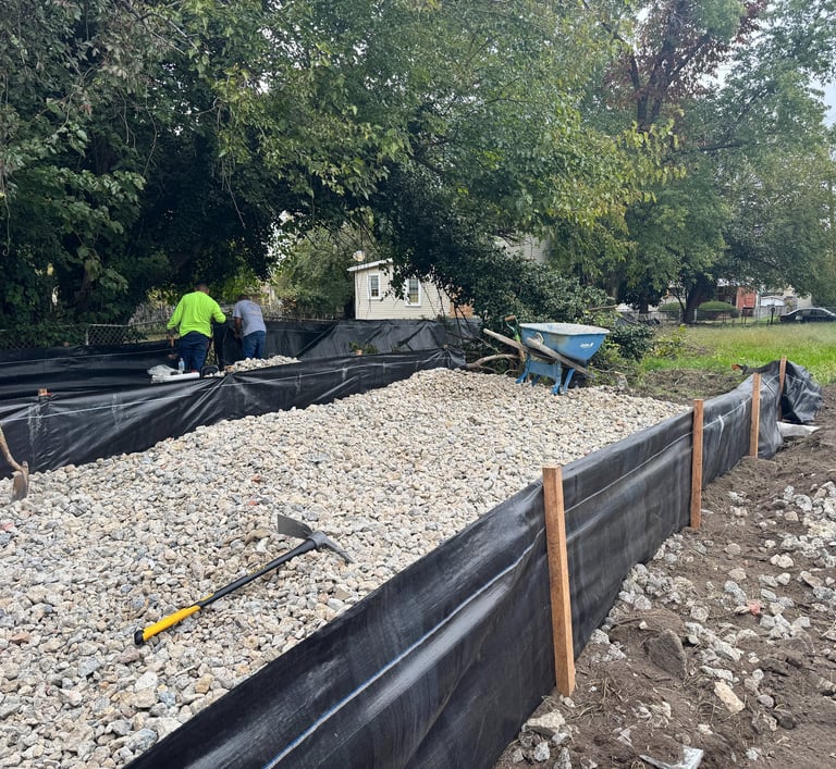 a man is laying out the ground next to a pile of gravel
