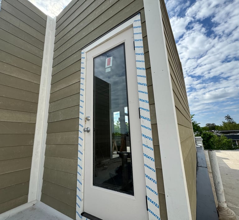 a door to a house with a white door and a blue sky