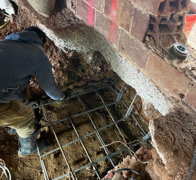 a man is working on a metal grate