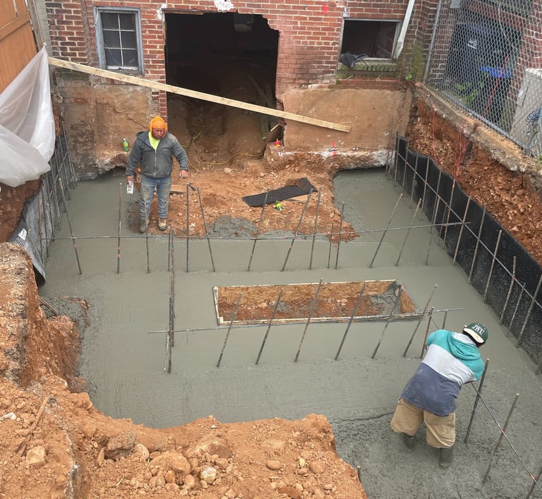 a man is working on a concrete slab in a construction site