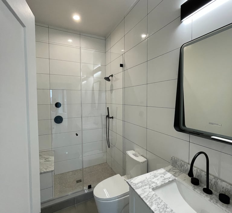 a bathroom with a toilet and a shower