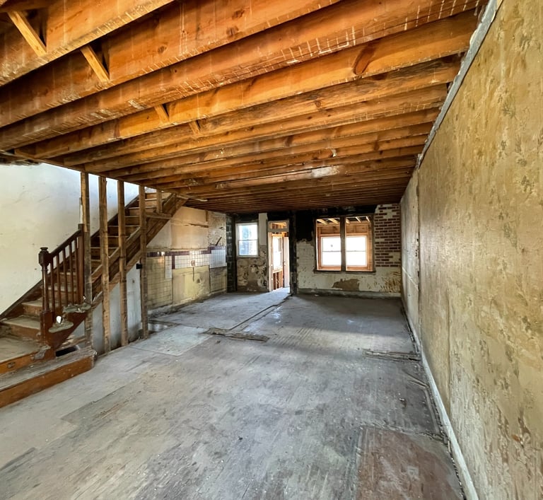 a room with a staircase and stairs leading up to a staircase