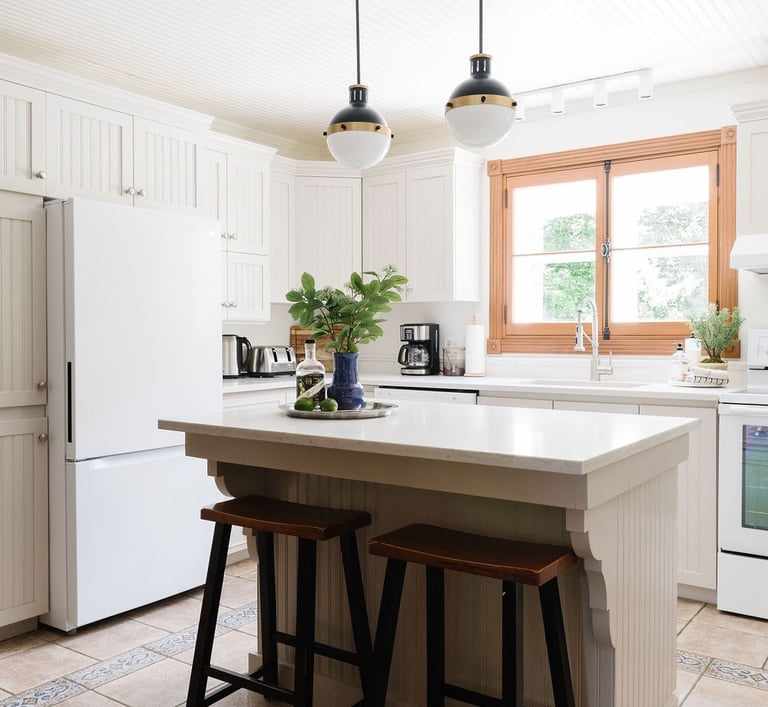 a kitchen with a large island and a white refrigerator