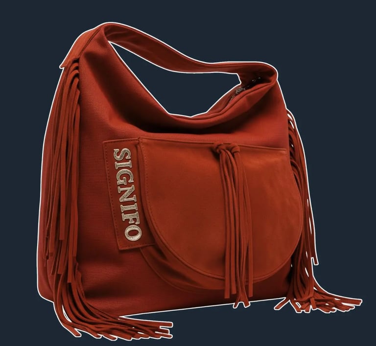 A large, soft, and unstructured 'hobo' or 'slouch' bag that drapes beautifully from the shoulder.