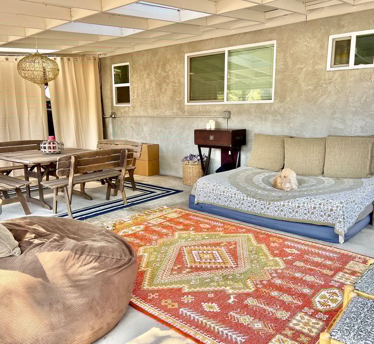 Covered outdoor lounge workspace and large table and ground spaces for therapeutic art expression