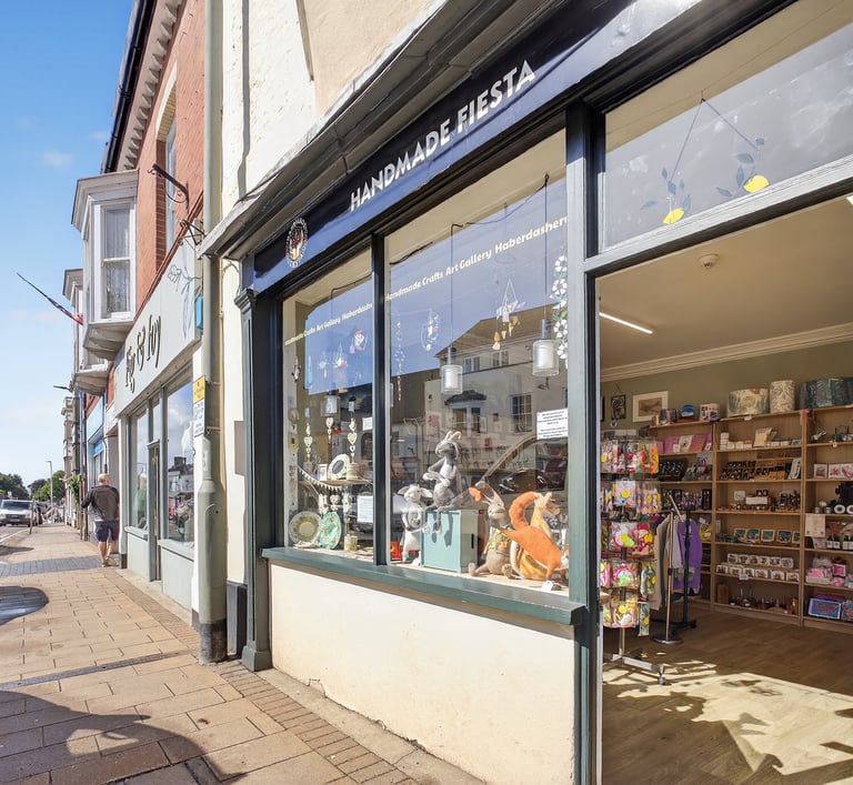 a store front door of a store with a dog sitting in the front of it
