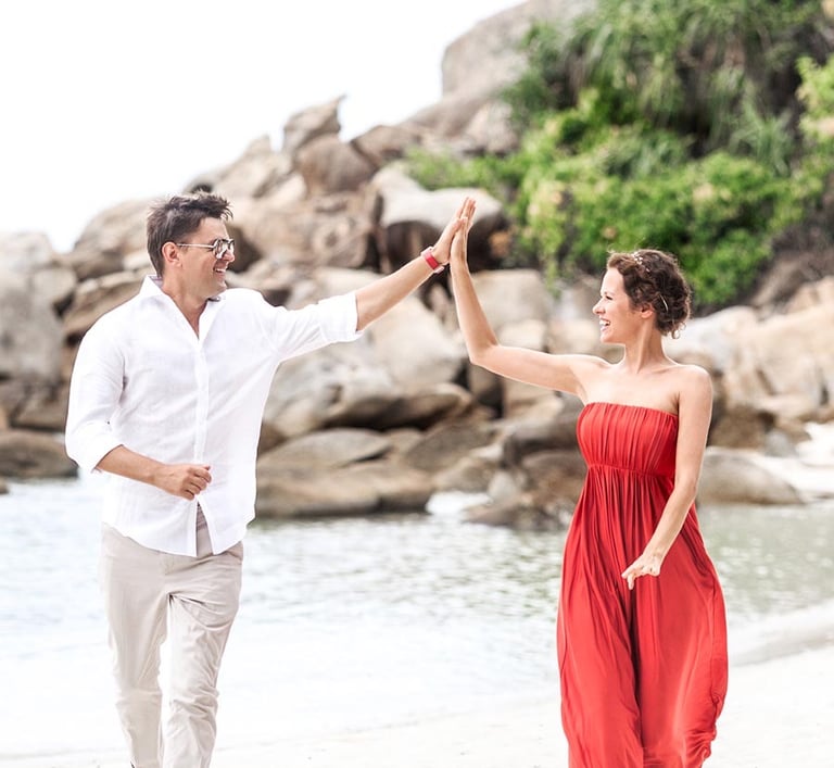 Couple giving high five on beach during Koh Samui photoshoot