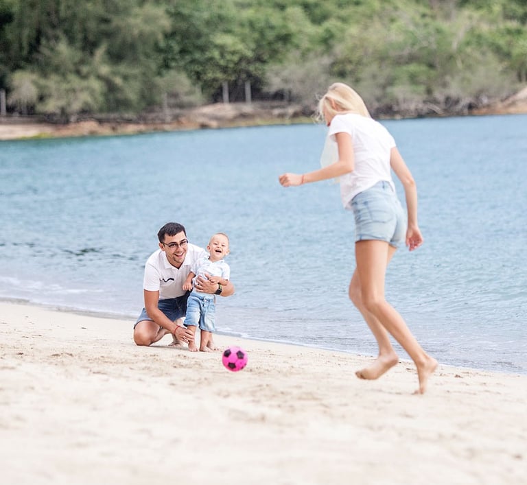 Family playing with baby on beach during Koh Samui photoshoot
