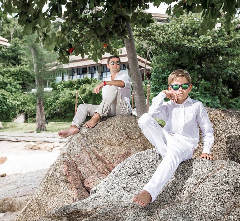 Father and son posing on rocks during Koh Samui family photoshoot