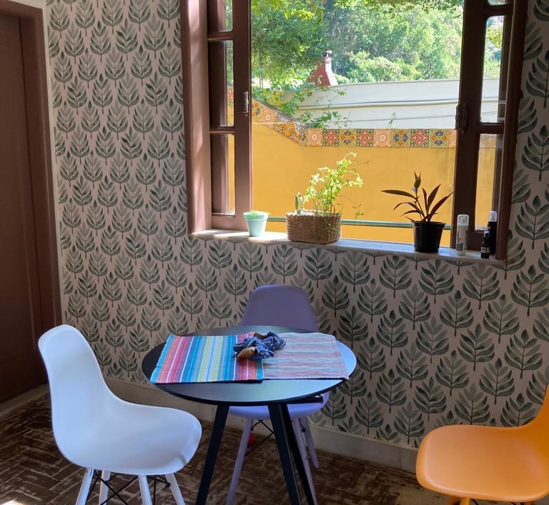 a table with a table and chairs in front of a window