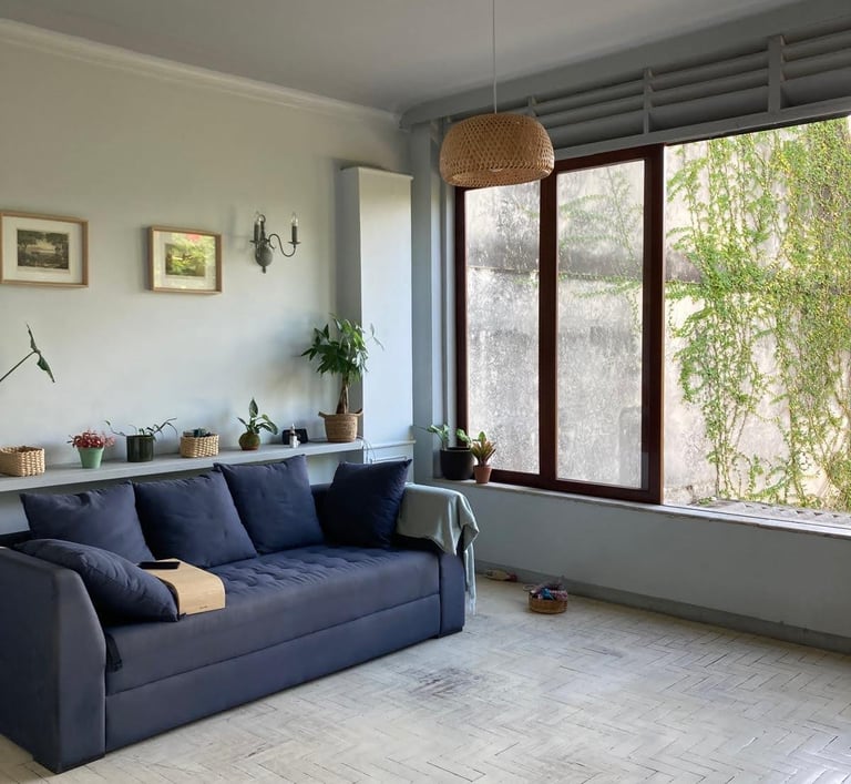 a couch in a living room with a large window