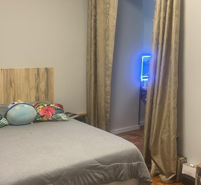 a bed with a bed and a television in a room