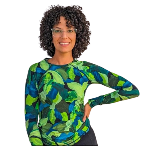 alt="Gina Nusret, infant swim instructor in South Florida smiling in blue and green shirt"