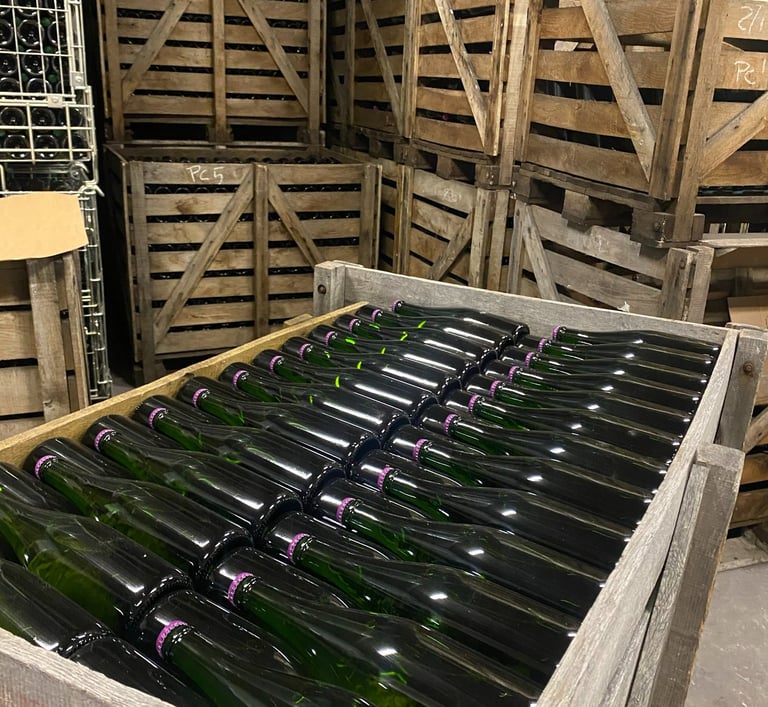 Champagne bottles lying in a wooden crate